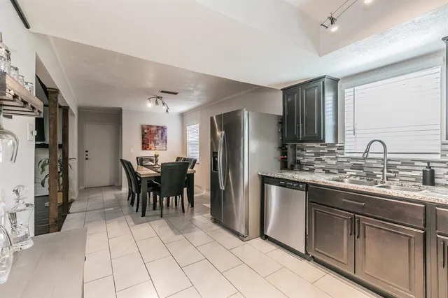 a kitchen with stainless steel appliances granite countertop a stove cabinets and microwave