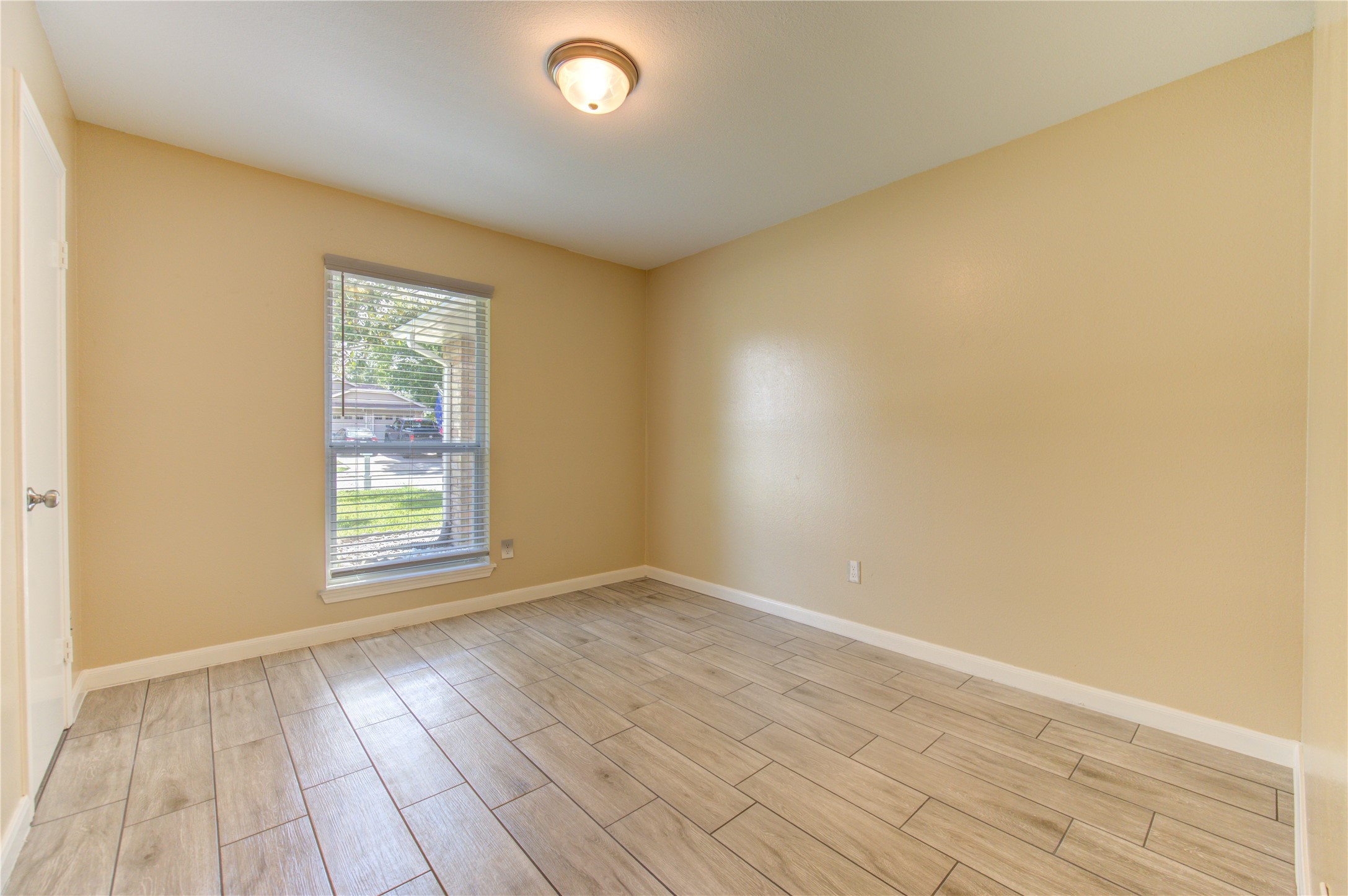 3702 Royal Manor Drive Houston, TX 77082 - Photo 14 of 29 an empty room with wooden floor and windows