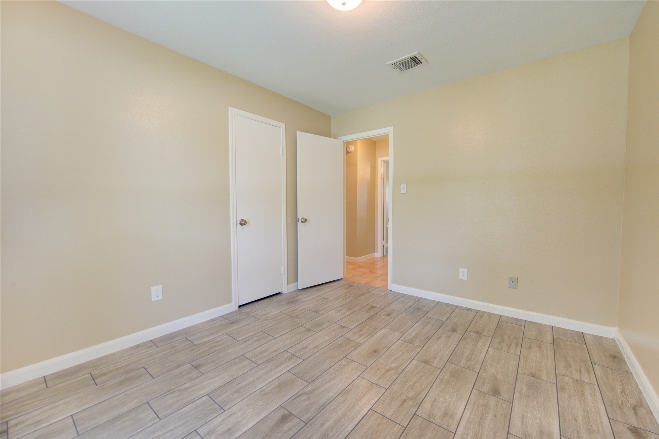 3702 Royal Manor Drive Houston, TX 77082 - Photo 18 of 29 a view of an empty room with wooden floor