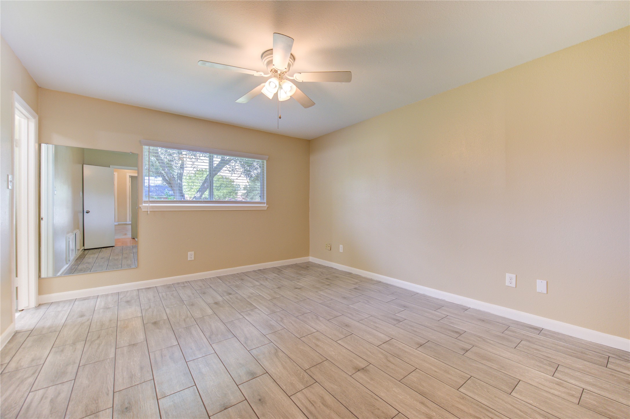 3702 Royal Manor Drive Houston, TX 77082 - Photo 19 of 29 wooden floor in an empty room with a window