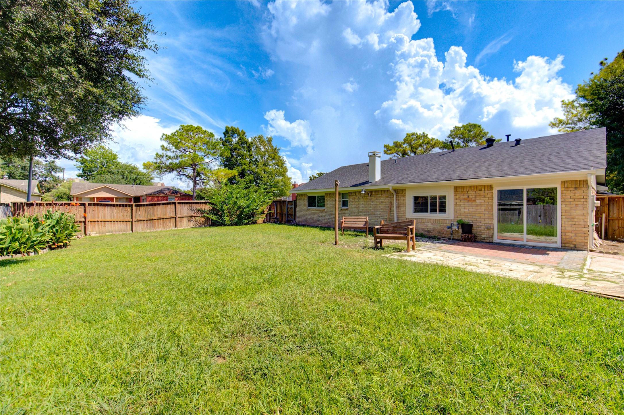 3702 Royal Manor Drive Houston, TX 77082 - Photo 26 of 29 a front view of a house with a garden