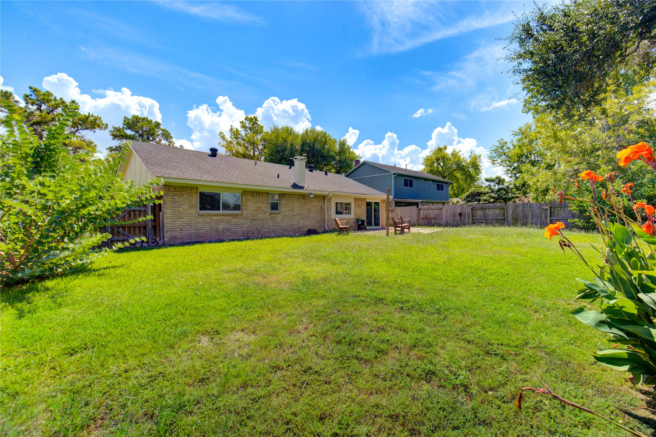 3702 Royal Manor Drive Houston, TX 77082 - Photo 27 of 29 a view of a house with a big yard potted plants and large tree