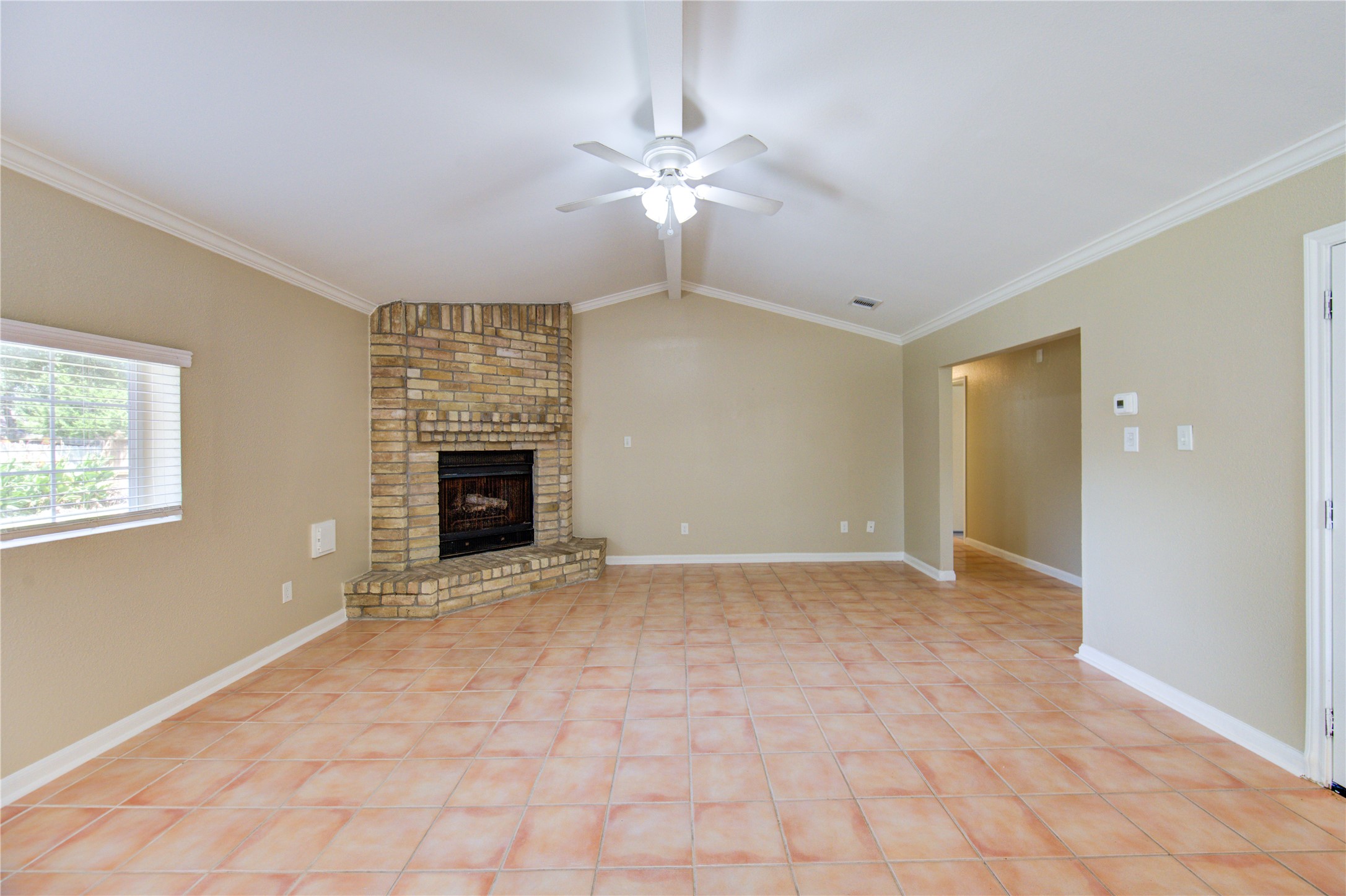 3702 Royal Manor Drive Houston, TX 77082 - Photo 7 of 29 a view of an empty room with a fireplace and a window