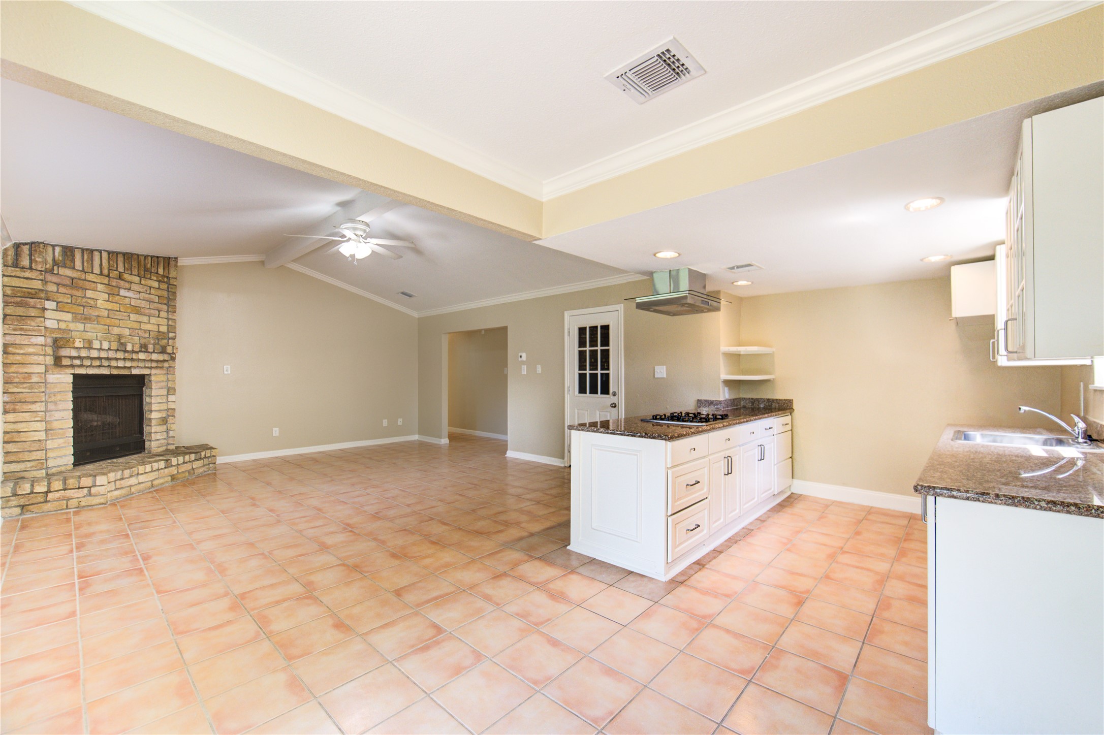 3702 Royal Manor Drive Houston, TX 77082 - Photo 8 of 29 a large white kitchen with granite countertop a sink cabinets and a stove