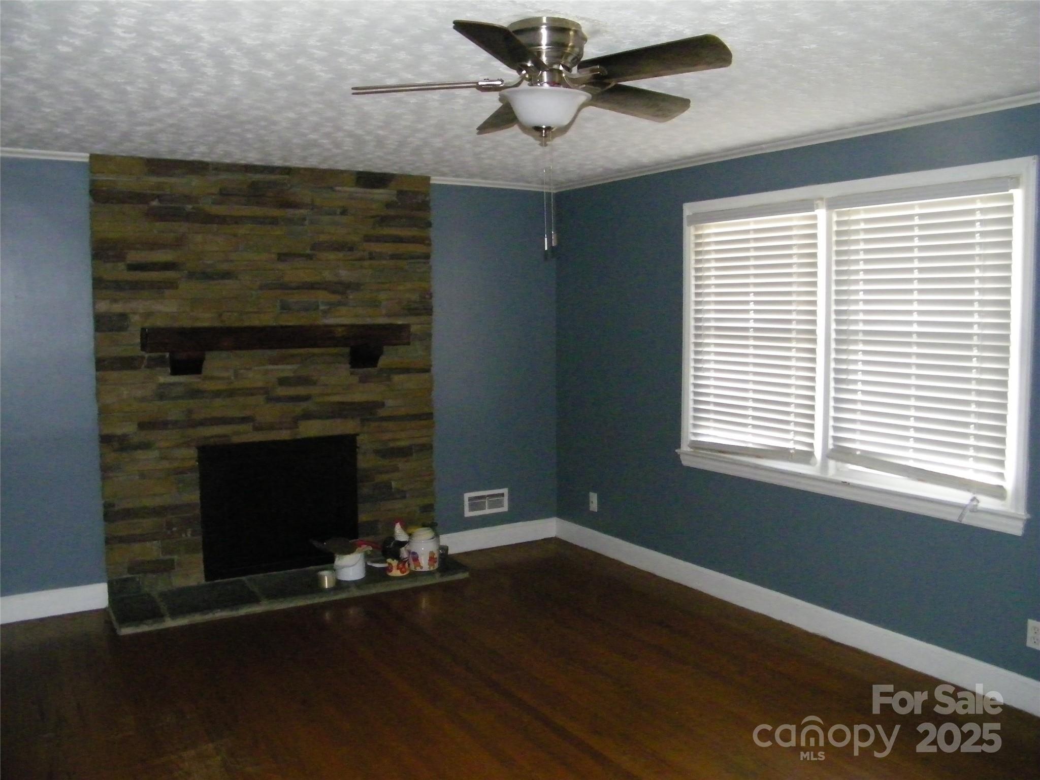 2353 South Post Road Shelby, NC 28152 - Photo 11 of 31 a living room with a fireplace and wooden floor
