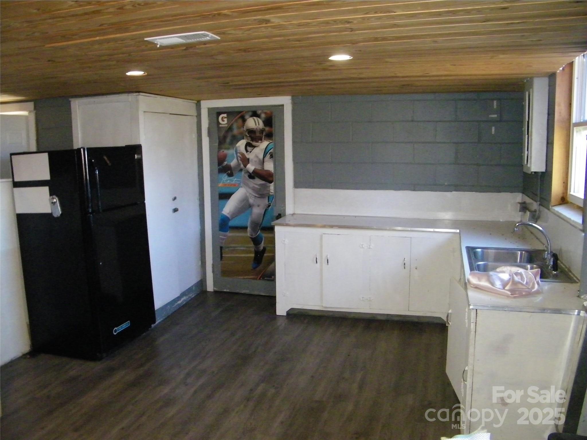 2353 South Post Road Shelby, NC 28152 - Photo 22 of 31 a view of a storage & utility room with fridge and wooden floor