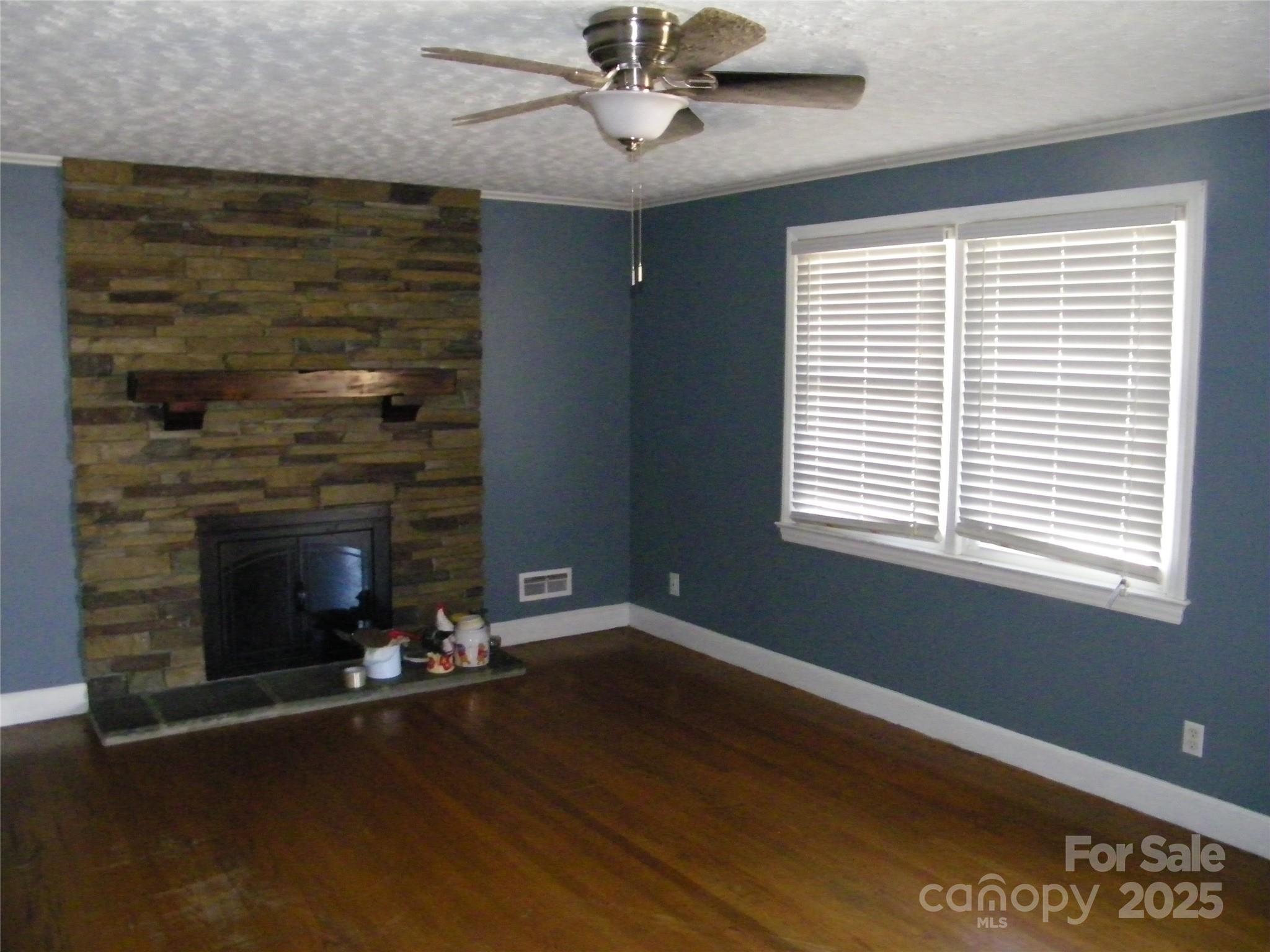 2353 South Post Road Shelby, NC 28152 - Photo 8 of 31 a living room with wooden floor and a fireplace
