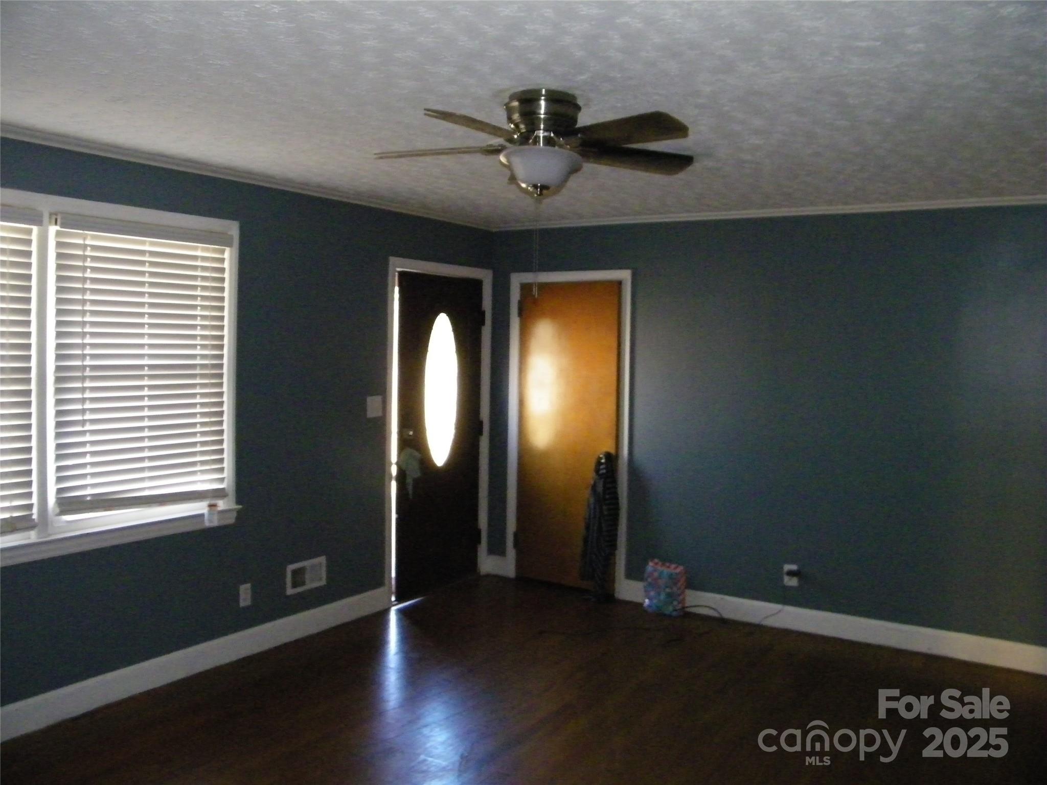 2353 South Post Road Shelby, NC 28152 - Photo 9 of 31 a view of a livingroom with wooden floor and a ceiling fan