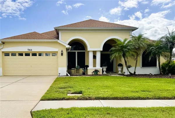 a view of house with yard and entertaining space