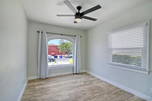 a view of a room with wooden floor and a bathroom