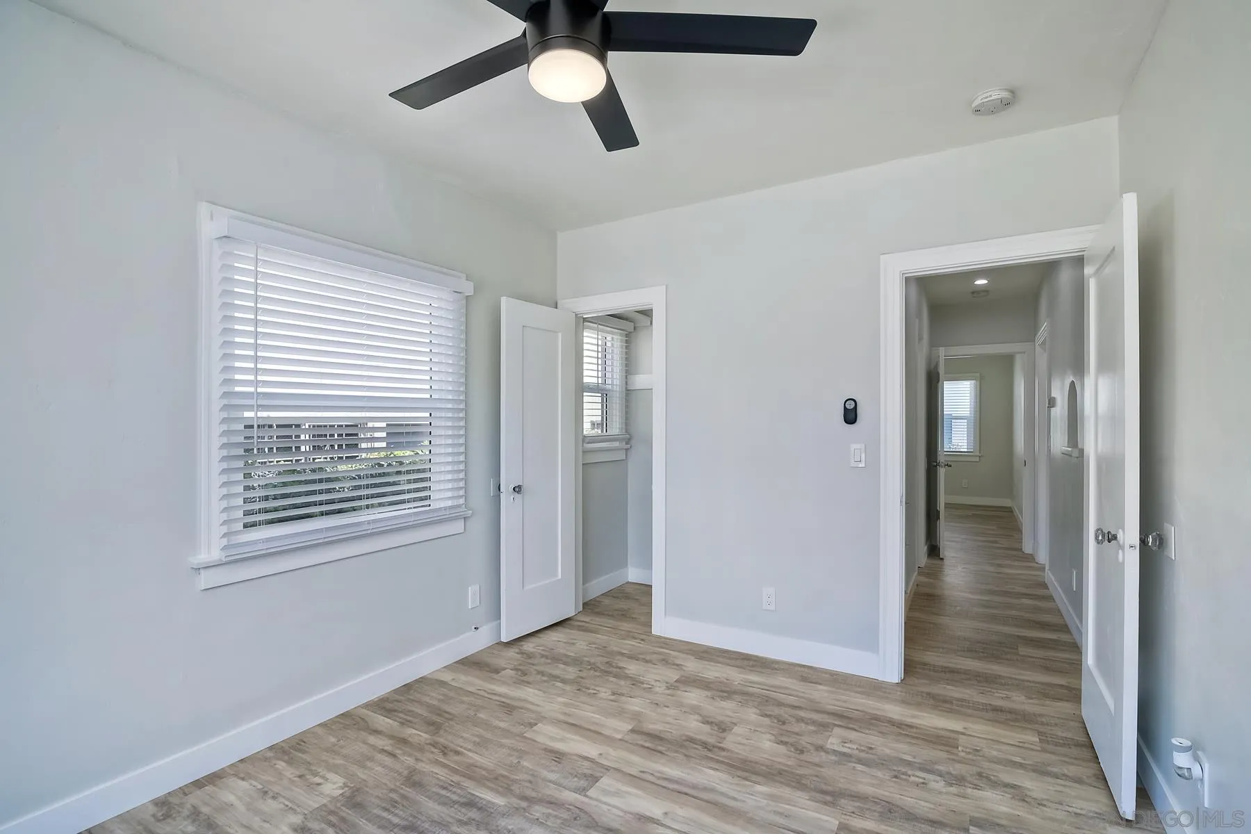 4685 Hamilton Street San Diego, CA 92116 - Photo 19 of 37 a view of an empty room with wooden floor and a window