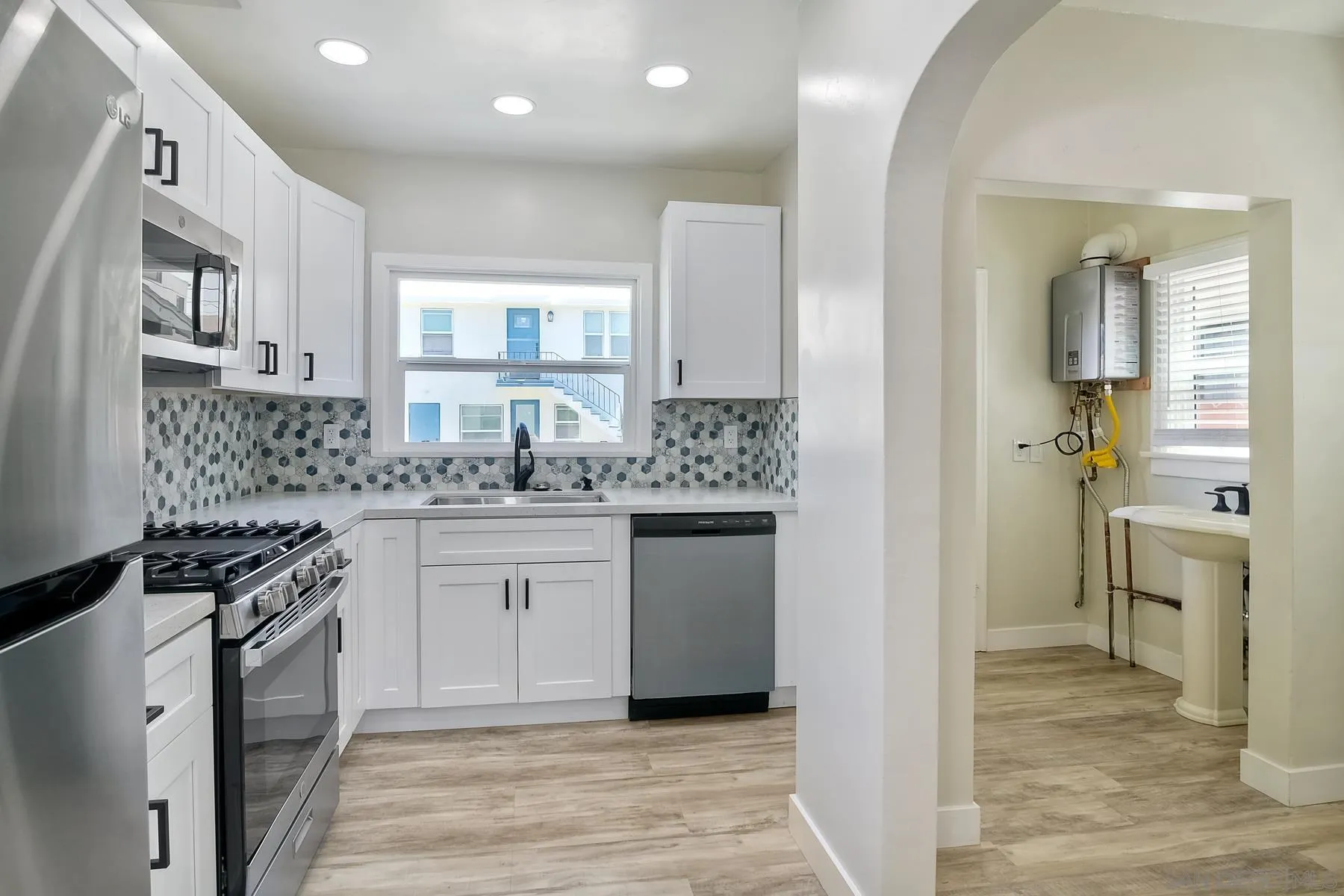4685 Hamilton Street San Diego, CA 92116 - Photo 20 of 37 a kitchen with a sink stove and refrigerator