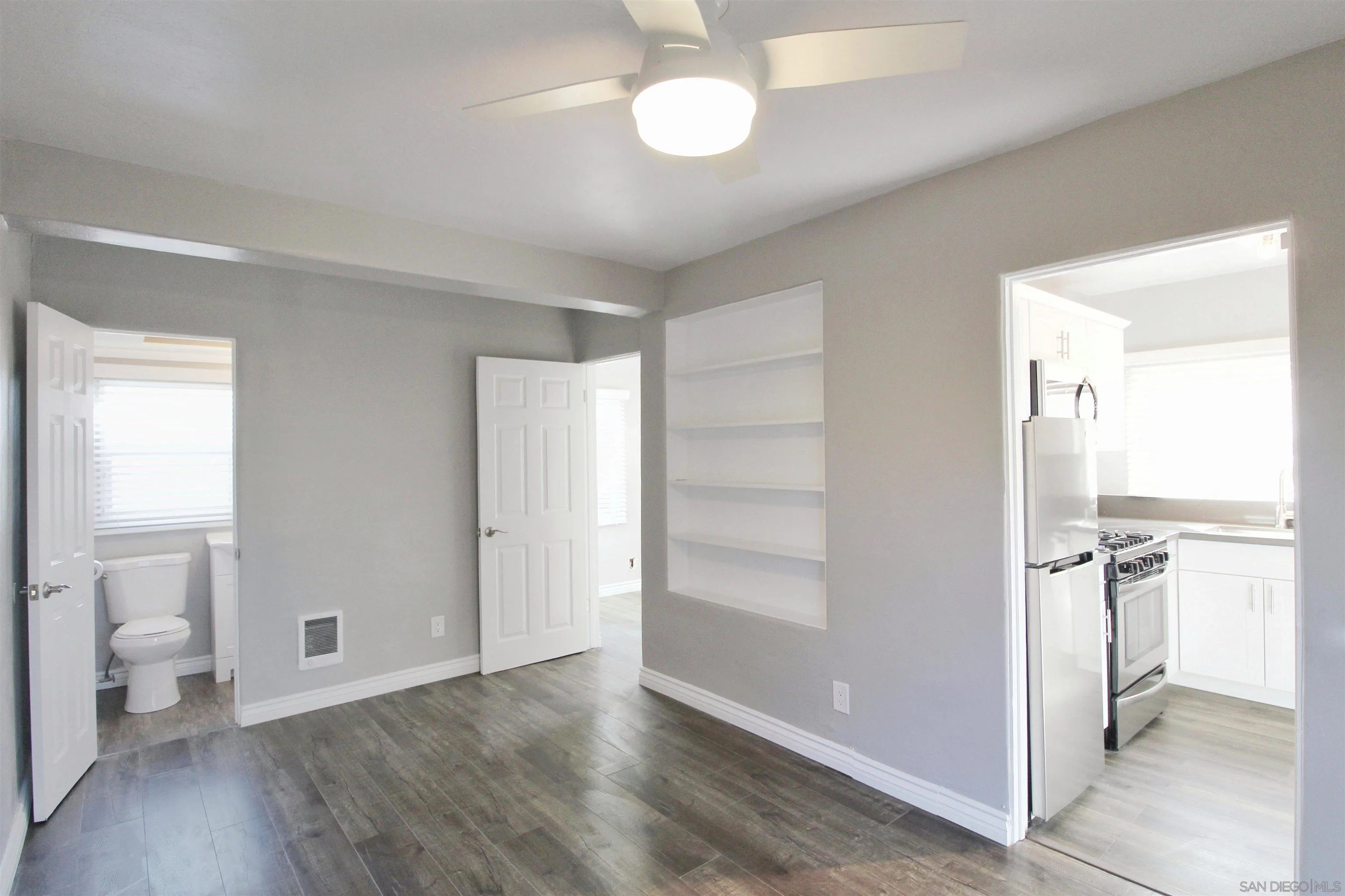 4685 Hamilton Street San Diego, CA 92116 - Photo 25 of 37 a view of a room with wooden floor and a bathroom