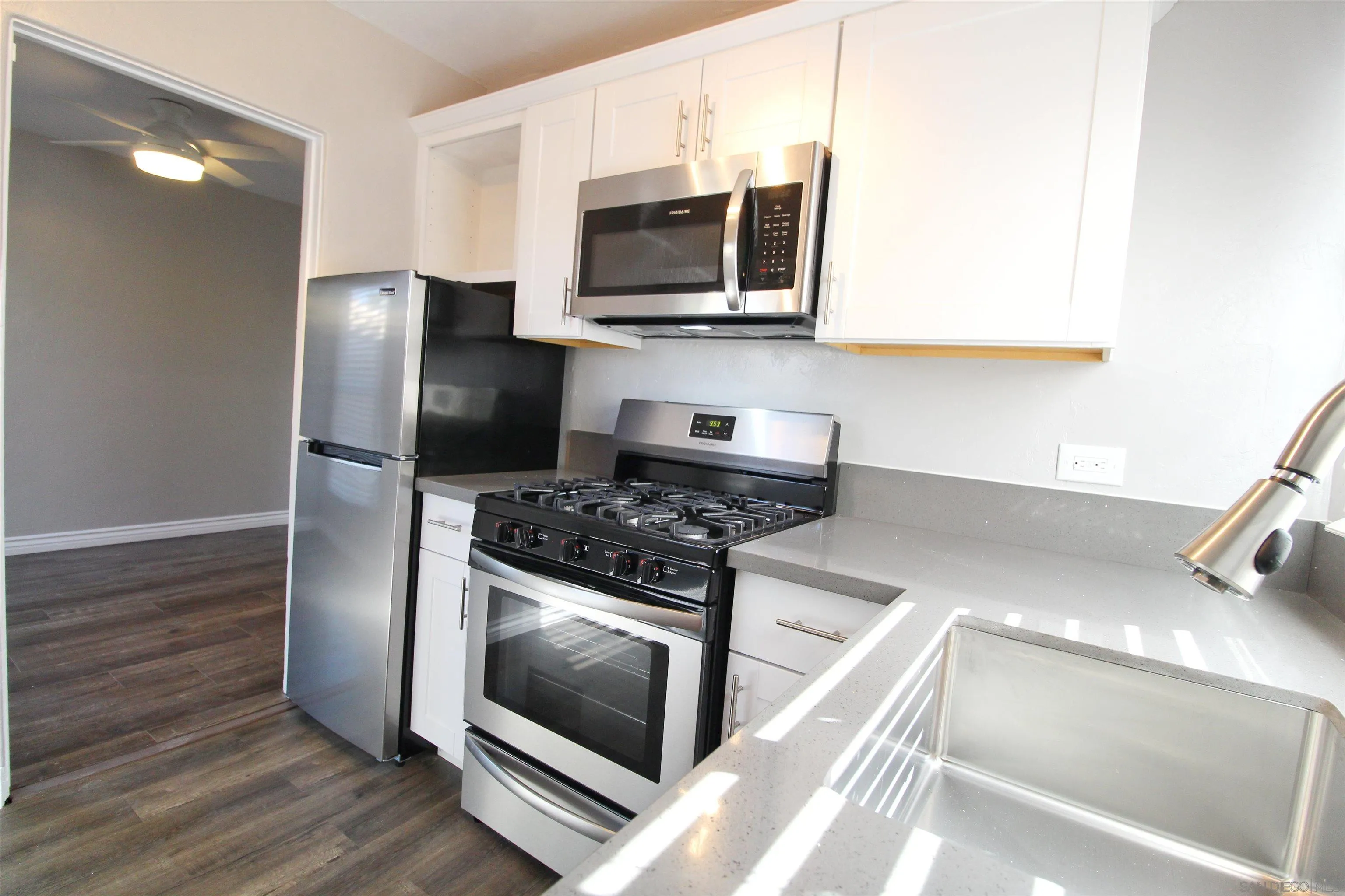 4685 Hamilton Street San Diego, CA 92116 - Photo 26 of 37 a kitchen with stainless steel appliances granite countertop a stove a microwave and a refrigerator