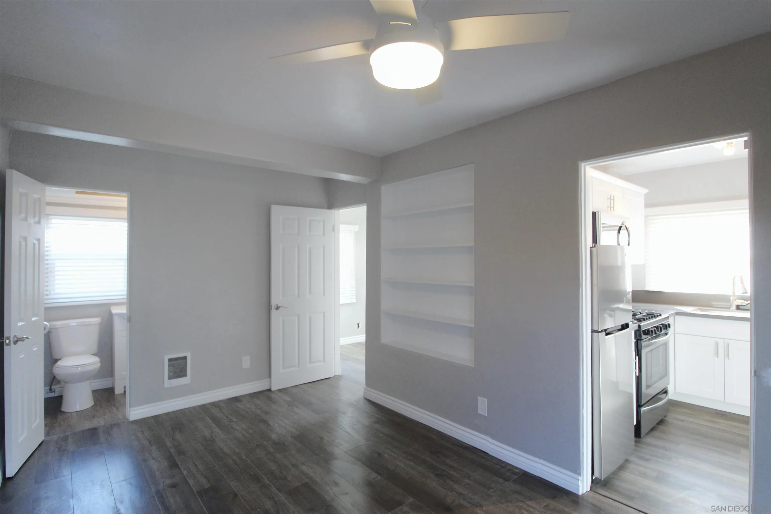 4685 Hamilton Street San Diego, CA 92116 - Photo 27 of 37 a view of a room with wooden floor and a bathroom