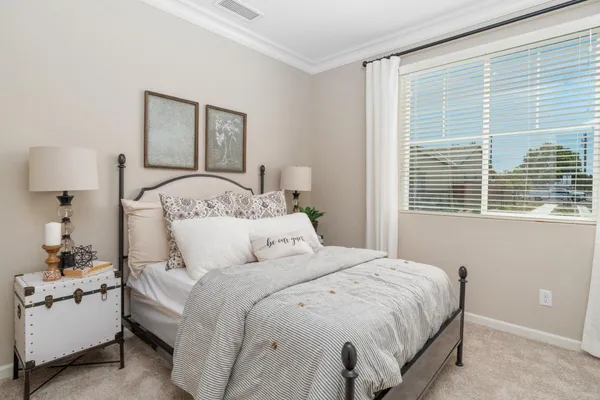 a bedroom with a bed and a night stand