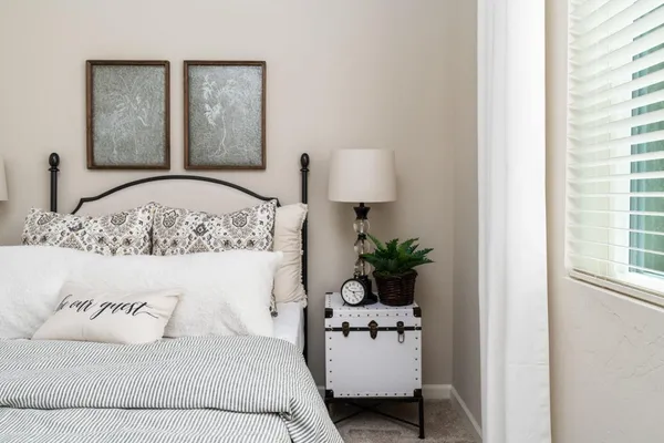 a bedroom with a bed and a lamp on table
