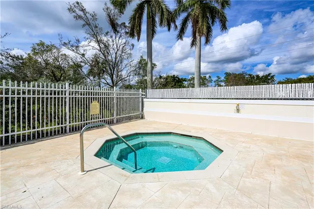a view of a swimming pool with a patio and a yard
