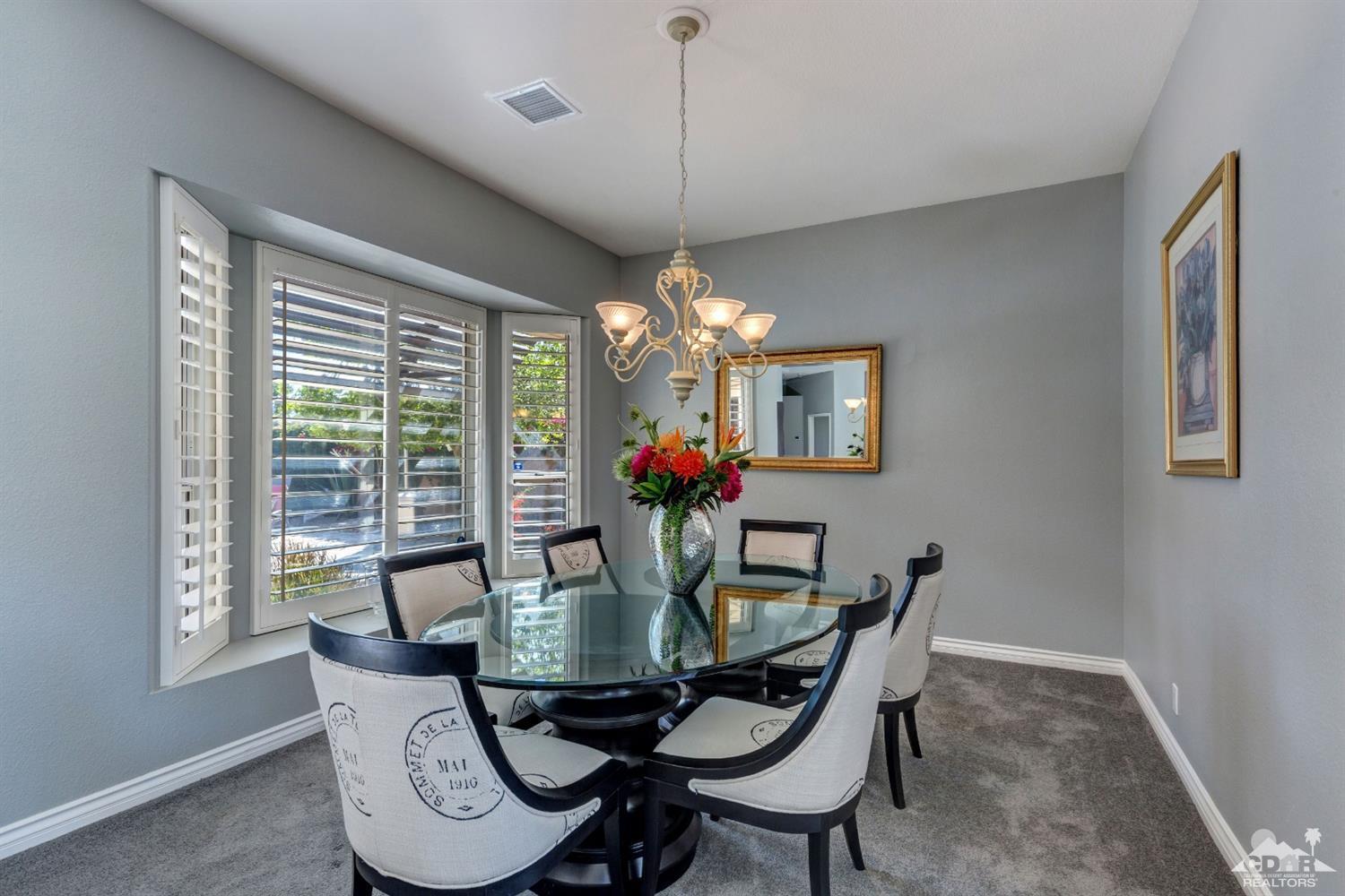 2 Hilton Head Drive Rancho Mirage, CA 92270 - Photo 14 of 40 a dining room with furniture a chandelier and window