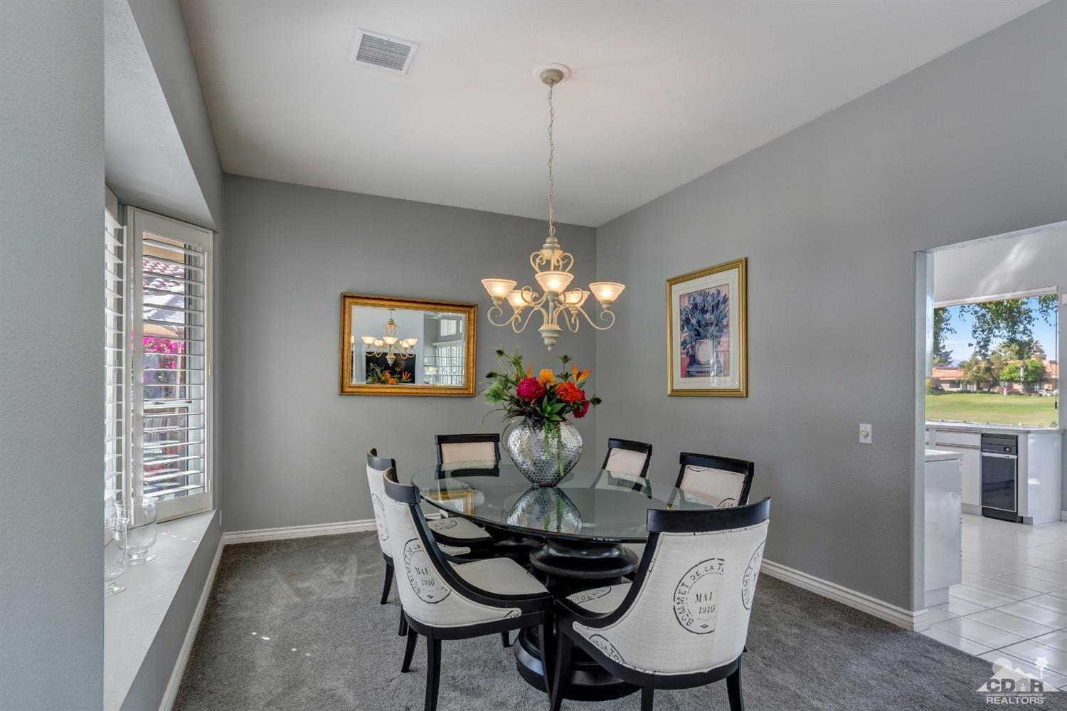 2 Hilton Head Drive Rancho Mirage, CA 92270 - Photo 15 of 40 a dining room with furniture a chandelier and wooden floor