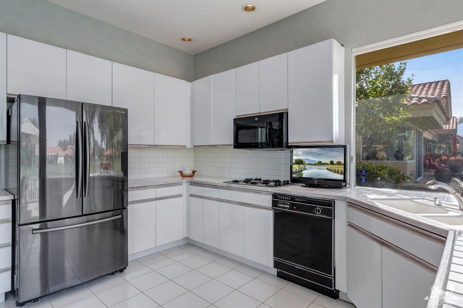2 Hilton Head Drive Rancho Mirage, CA 92270 - Photo 16 of 40 a kitchen with stainless steel appliances a refrigerator sink and microwave