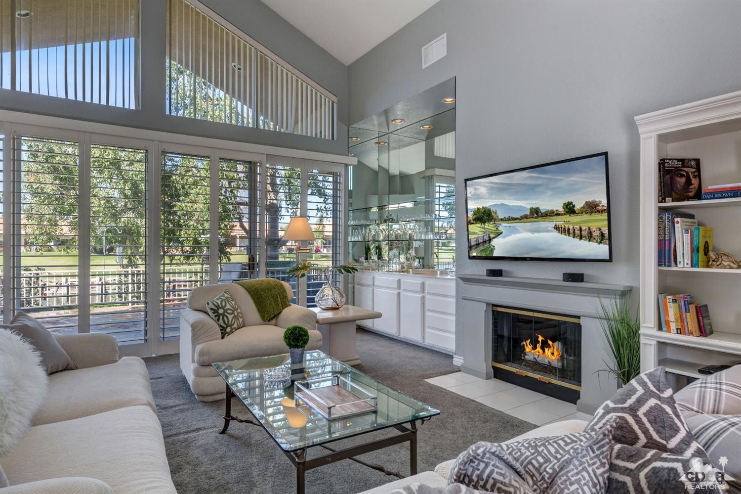 2 Hilton Head Drive Rancho Mirage, CA 92270 - Photo 3 of 40 a living room with furniture a fireplace and a flat screen tv