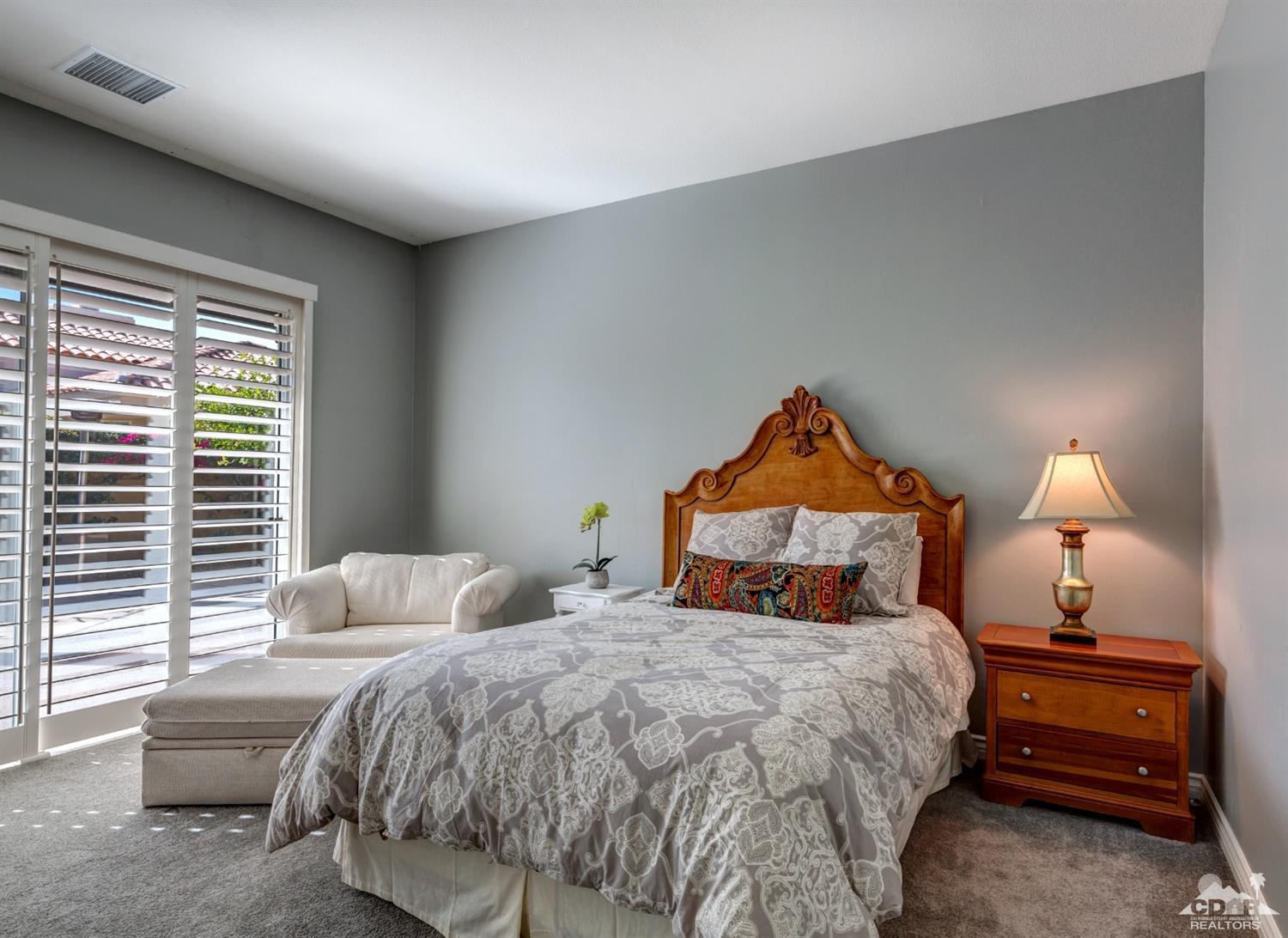 2 Hilton Head Drive Rancho Mirage, CA 92270 - Photo 26 of 40 a bedroom with a bed and a lamp on table