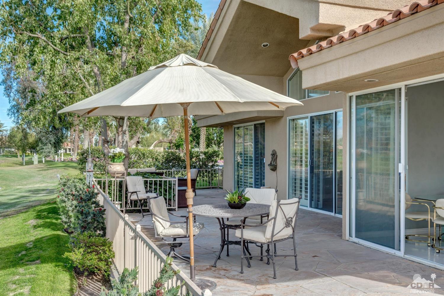 2 Hilton Head Drive Rancho Mirage, CA 92270 - Photo 34 of 40 a view of a patio with table and chairs under an umbrella