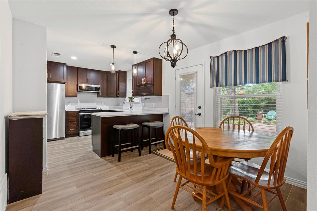 9013 Topperwind Court Fort Worth, TX 76134 - Photo 6 of 32 Dining area in kitchen and window to view the lush backyard