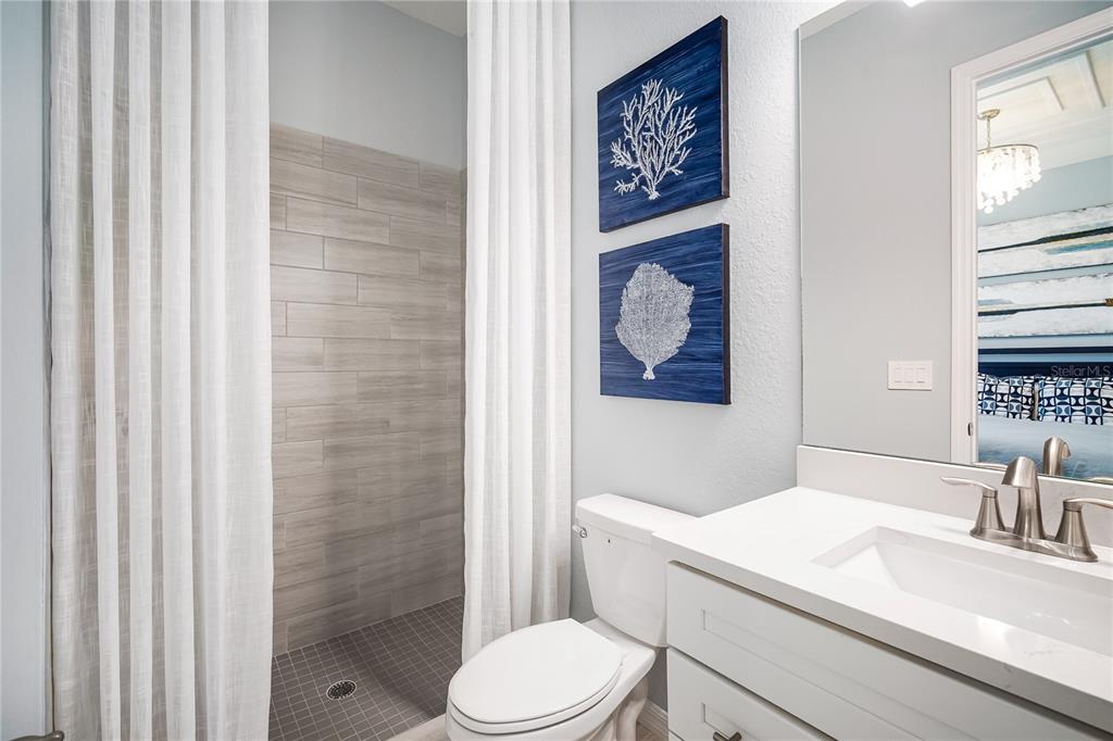 7165 Inlet Isles Lakewood Ranch, FL 34202 - Photo 18 of 26 a bathroom with a toilet a sink and a window
