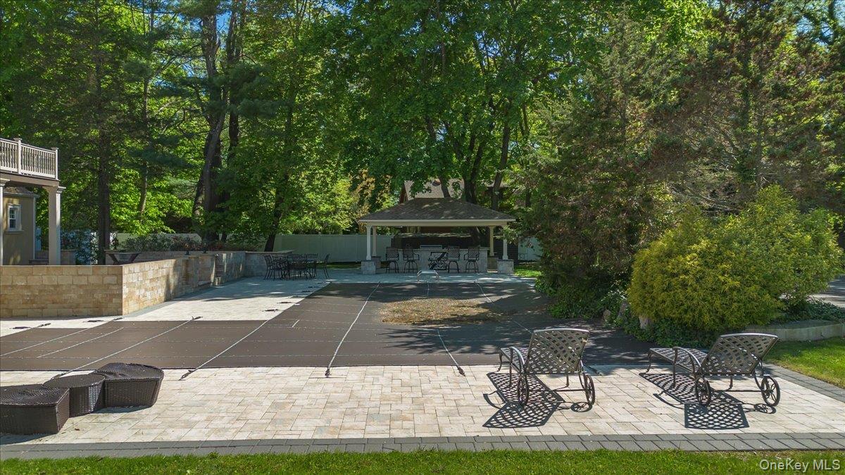 626 Caledonia Road Dix Hills, NY 11746 - Photo 40 of 49 a view of a patio with table and chairs with wooden floor and fence