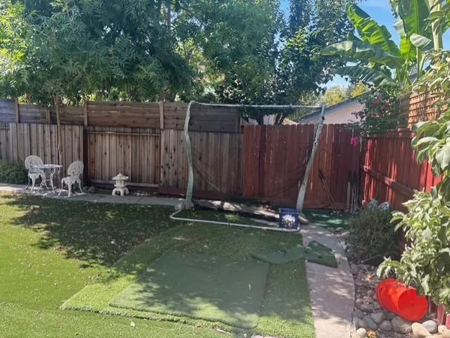 a backyard of a house with table and chairs
