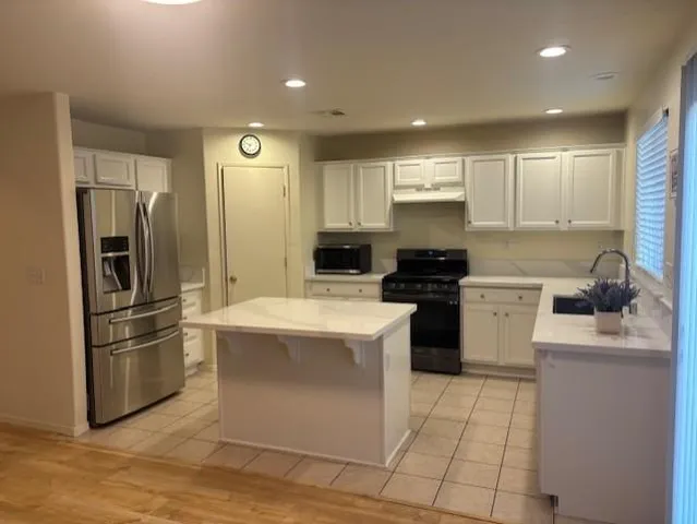 a kitchen with a sink stainless steel appliances and cabinets