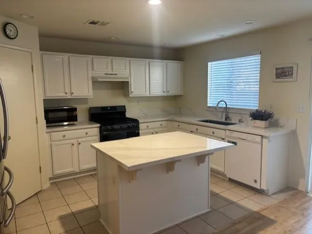 a kitchen with a sink stove and cabinets