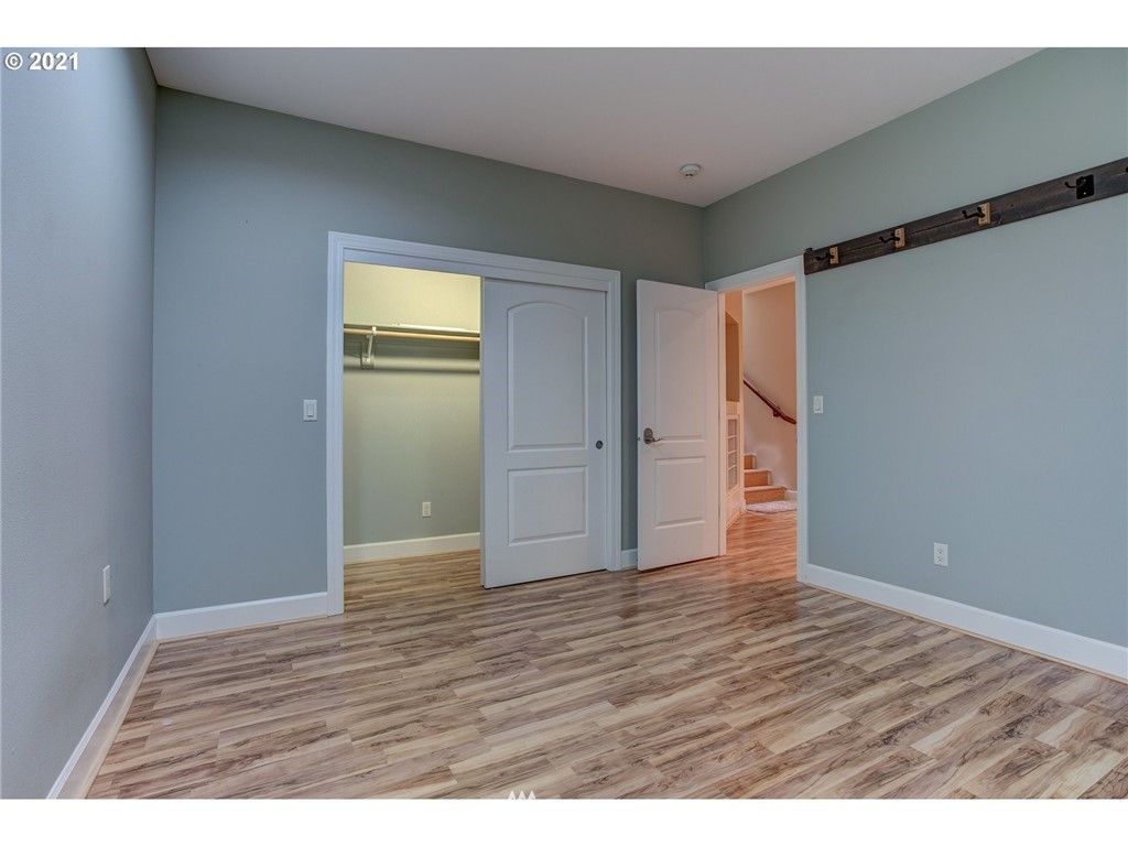 907 North 8th Place Ridgefield, WA 98642 - Photo 22 of 31 a view of an empty room with wooden floor