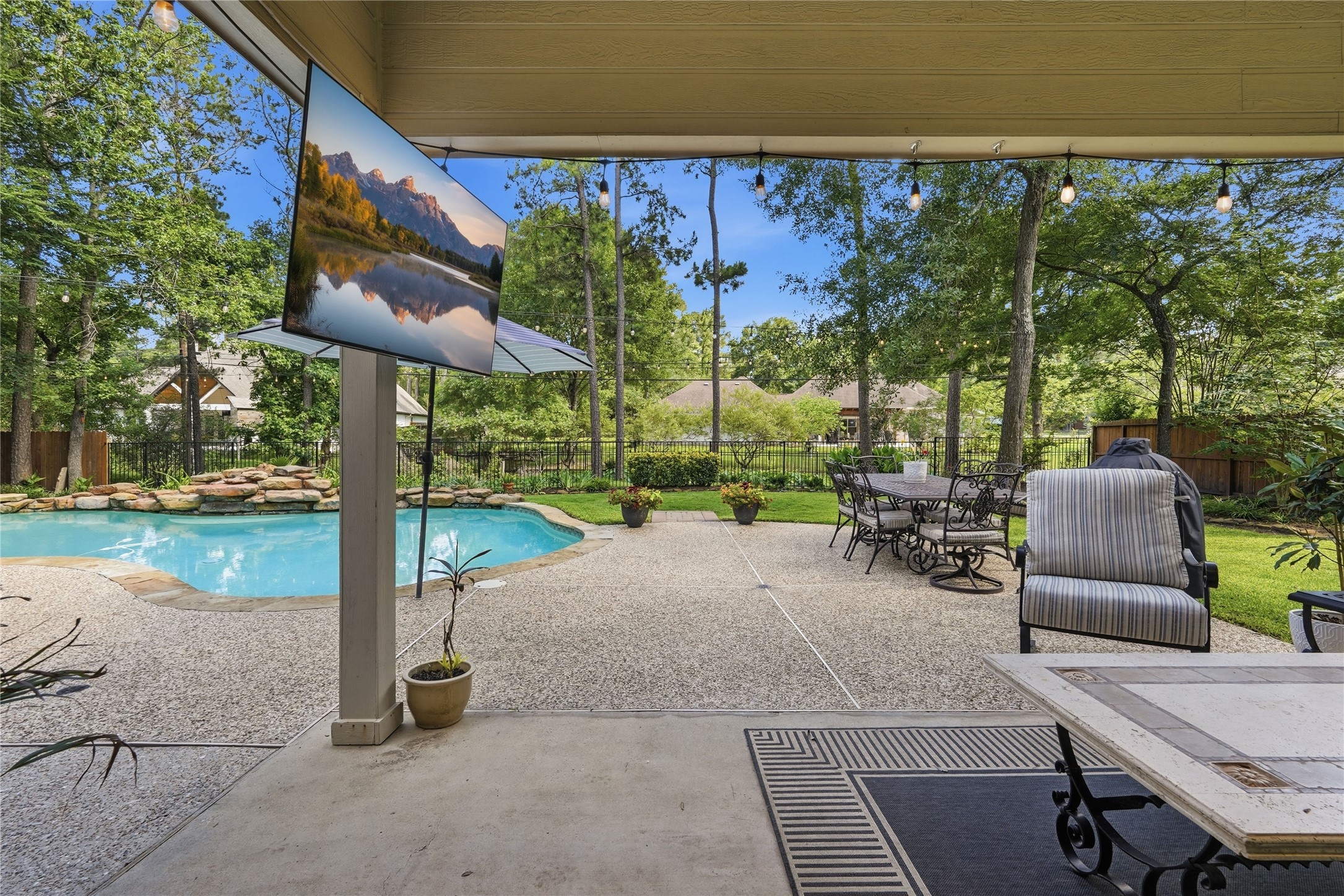 2408 Hollowbrook Lane Conroe, TX 77384 - Photo 34 of 49 View from the back door leading out to covered patio, pool and back yard oasis!