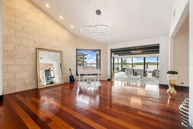 a living room with furniture a rug and a large window