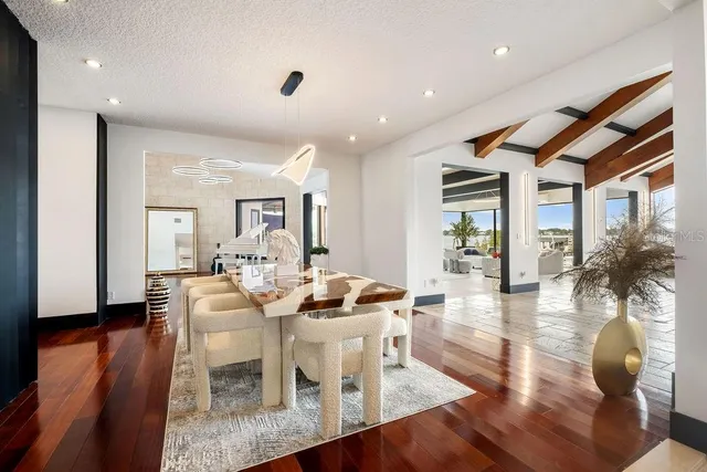 a living room with stainless steel appliances furniture and a flat screen tv