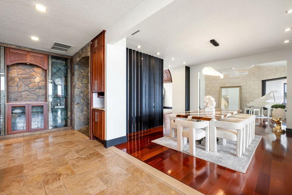 2844 Marquesas Court Windermere, FL 34786 - Photo 24 of 75 a living room with stainless steel appliances granite countertop furniture a fireplace a rug and a large window
