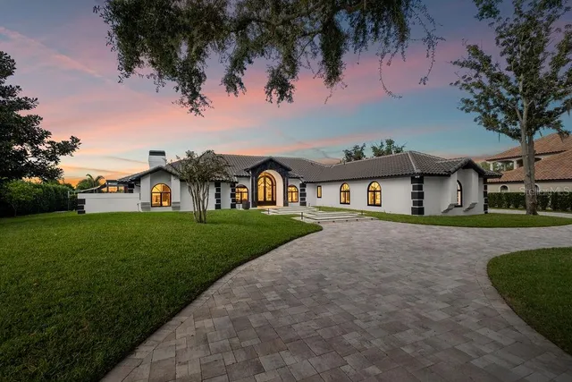a front view of a house with yard and green space