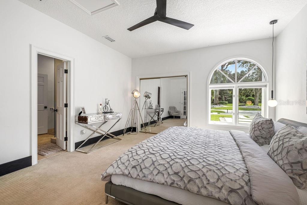 2844 Marquesas Court Windermere, FL 34786 - Photo 48 of 75 a spacious bedroom with a bed and a large window