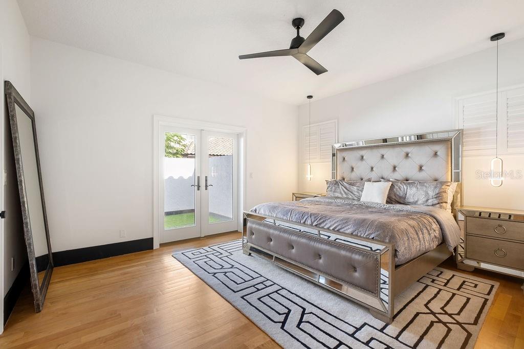 2844 Marquesas Court Windermere, FL 34786 - Photo 50 of 75 a bedroom with a large bed and a ceiling fan