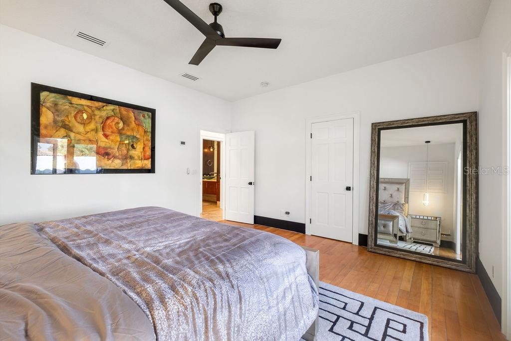 2844 Marquesas Court Windermere, FL 34786 - Photo 51 of 75 a spacious bedroom with a bed and a dresser next to a window