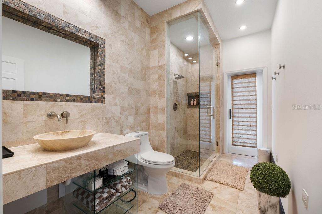 2844 Marquesas Court Windermere, FL 34786 - Photo 52 of 75 a bathroom with a granite countertop sink a toilet a mirror and shower