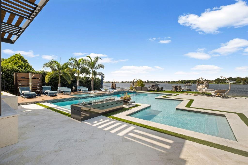 2844 Marquesas Court Windermere, FL 34786 - Photo 61 of 75 a view of a swimming pool with a lounge chairs