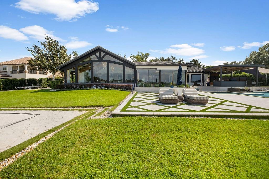 2844 Marquesas Court Windermere, FL 34786 - Photo 64 of 75 a view of a house with swimming pool and a yard