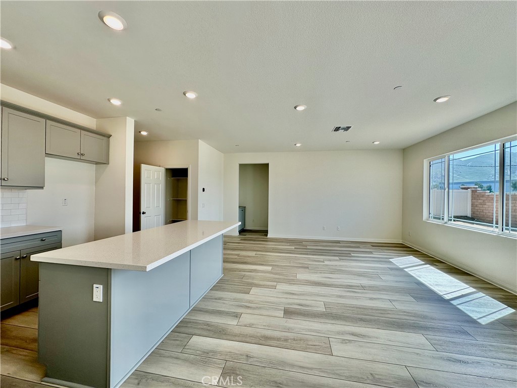 19549 Sunkissed Rdg Drive Riverside, CA 92507 - Photo 6 of 17 a large kitchen with kitchen island a sink stainless steel appliances and cabinets