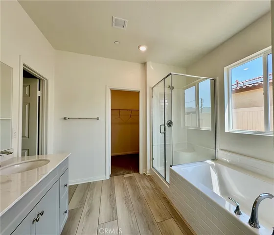 a bathroom with a tub sink shower and mirror