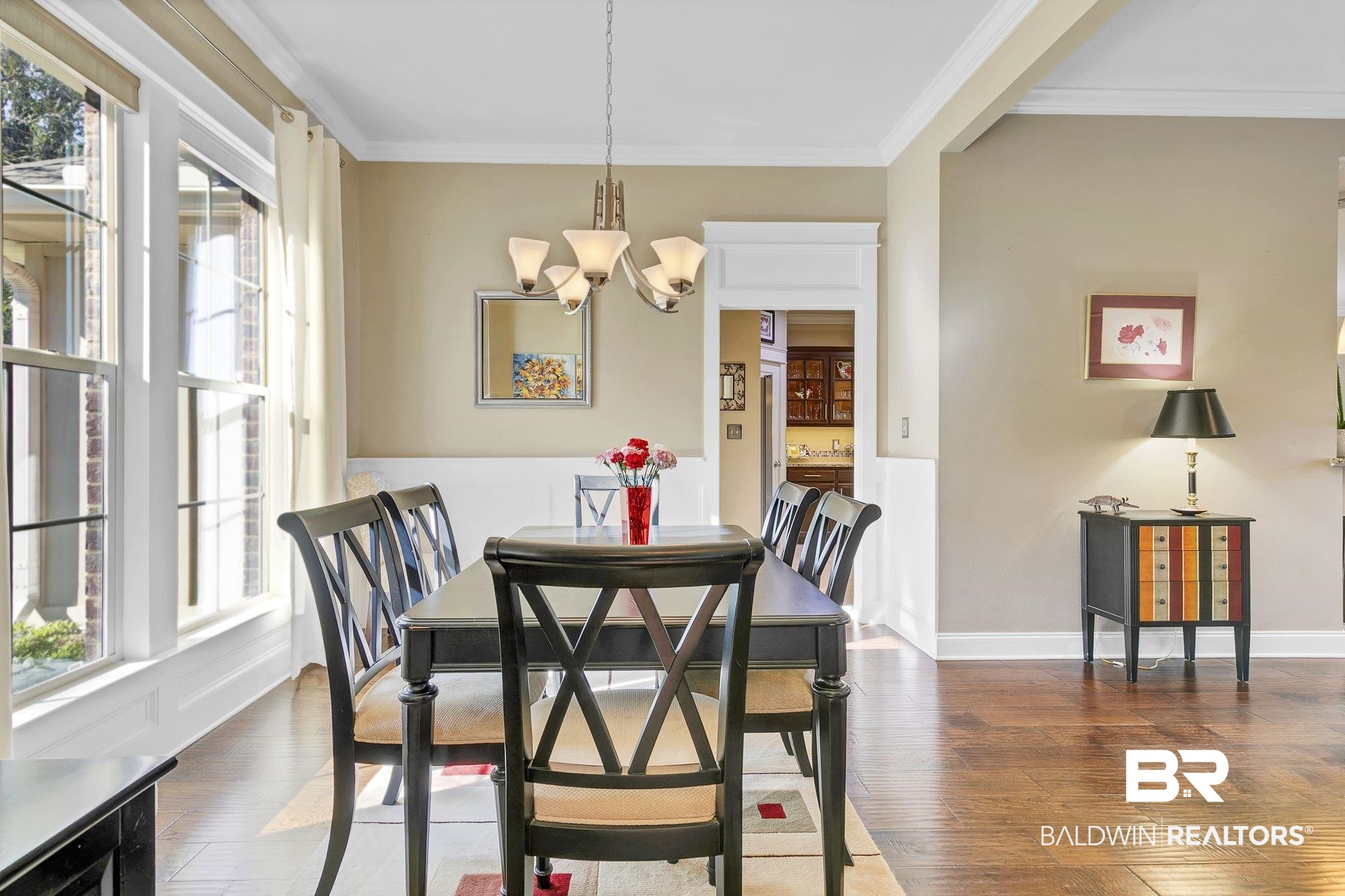 20105 Bunker Loop Fairhope, AL 36532 - Photo 19 of 65 Dining room featuring an inviting chandelier, crown molding, wood finished floors, and baseboards