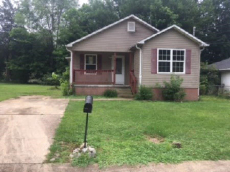 122 Booker Street Jackson, TN 38301 - Photo 1 of 18 a front view of a house with a yard